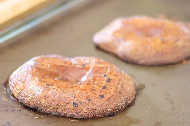 Carefully transfer the caps, gill-side up, on the preheated baking sheet.