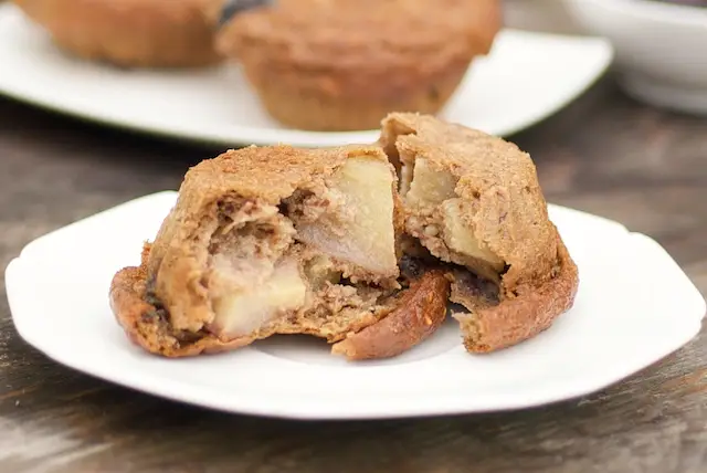 Tear the muffin into the half, and now we can see the beautiful chunks of apples and blueberries.