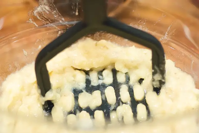 Using a potato masher or fork mash the bananas.
