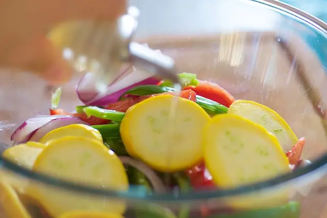 Put all the chopped veggies into a large mixing bowl, drizzle some olive oil.