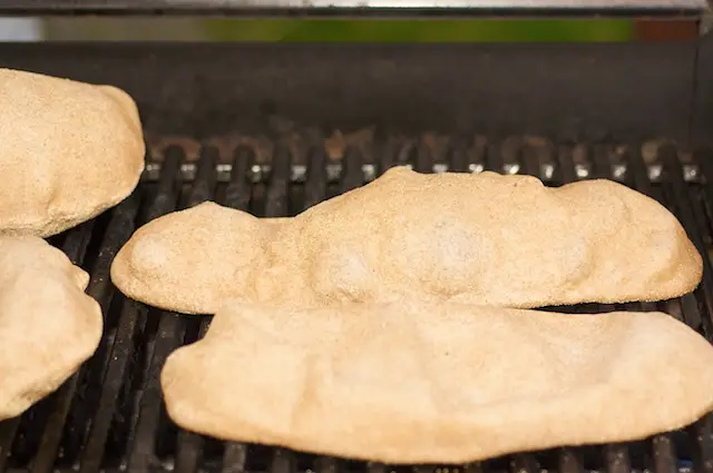Time to grill the pizza dough. Place the pizza dough on the grill. 