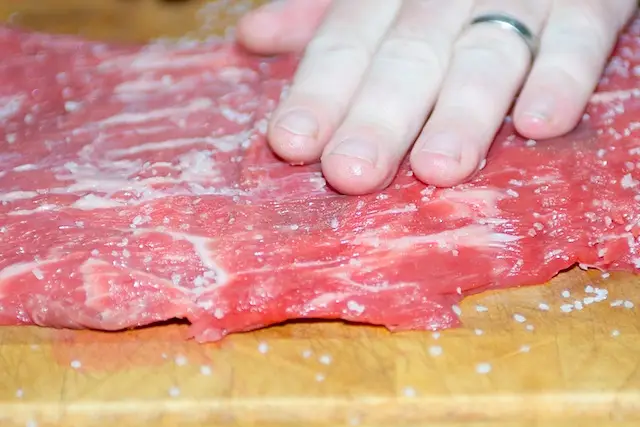 Rub the salt into the steak