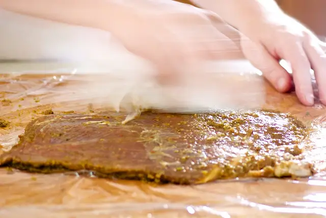 Wipe off excess marinade with paper towels