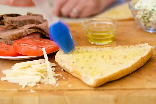 Brush bread with garlic oil