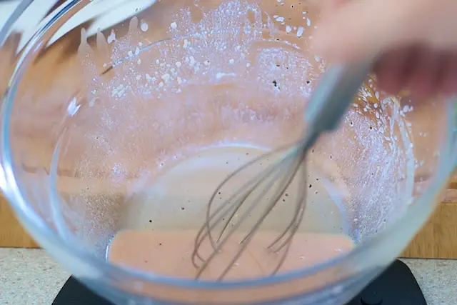 Add the vinegar, lemon juice, mustard, honey, salt and pepper in a large bowl, whisk until well blended. 