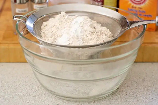 Add the flour, baking powder, and baking soda into a fine sieve over a large bowl.