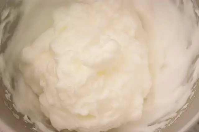 Beat the egg whites until soft peaks form.