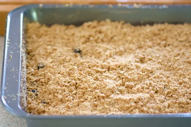 Sprinkle the streusel topping evenly over the blueberries and batter. 
