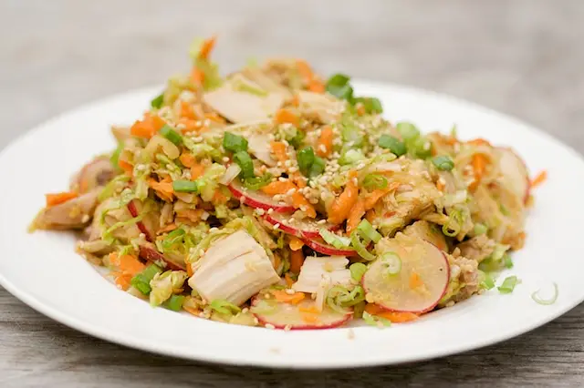 Whisk dressing again and drizzle over the salad, toss to evenly coat.