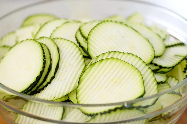 All the zucchinis have been beautifully sliced, place into a large bowl.