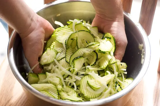 Place the zucchini, onion and salt in a colander, toss to coat and place over a bowl. 