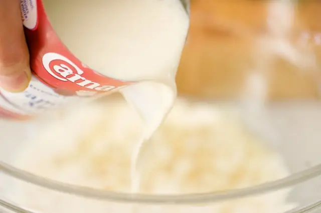 Pour the evaporated milk into the bowl.