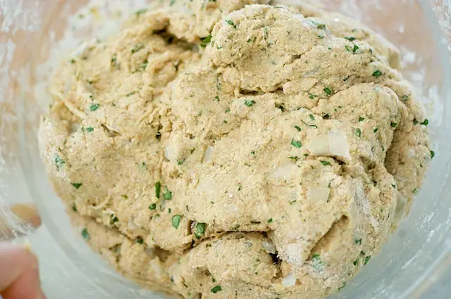 Stir by hand to make a moderately soft dough.