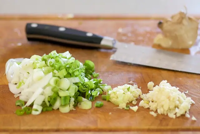Then slice the scallions, finely chop or mince the garlic and ginger.