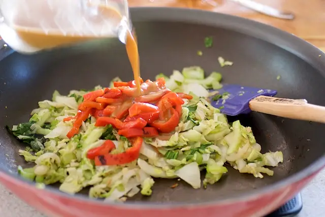 Stir in roasted bell peppers, pour sauce over vegetables.