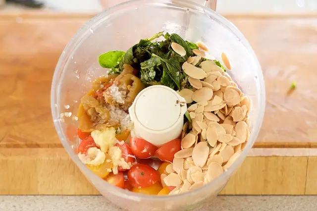 Finally add the toasted almonds, cherry tomatoes, basil, garlic, pickled banana or hot peppers, and salt to taste.