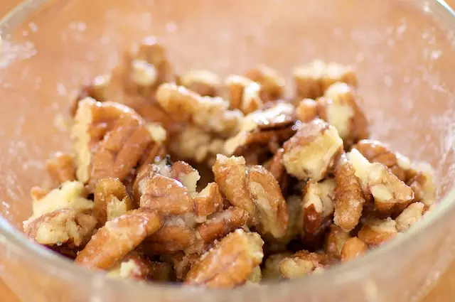 Toss until the pecans are well coated by butter and maple syrup.