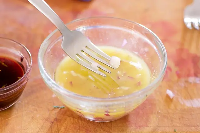 Mix together remaining lemon juice, olive oil and chopped red onions.