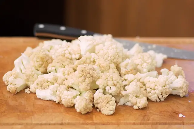 Trim off the ends of the cauliflower, and cut into small florets.