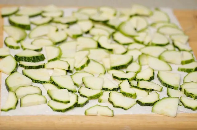 Line the sliced zucchini on several clean paper towels,