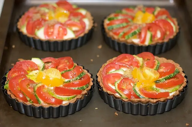 Top with sliced cherry tomatoes and zucchinis as picture shows. 