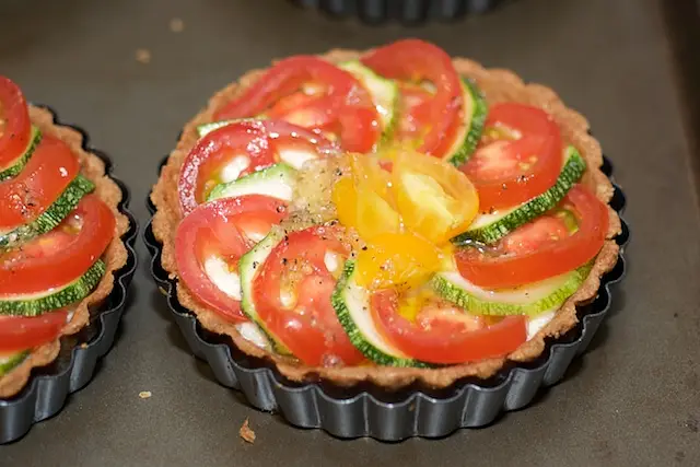 Spoon the garlic-olive oil mixture over the tomatos and zucchinis. 