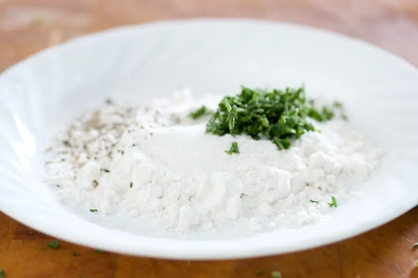 Season the <a href="/how-to/how-to-measure-flour" title="How to measure flour">flour</a> for dredging of the chicken cutlets