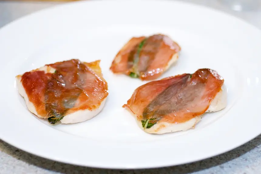 Plating, the cooked chicken saltimbocca