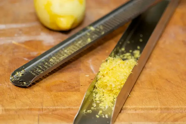 Freshly grate 1 lemon, and set aside.