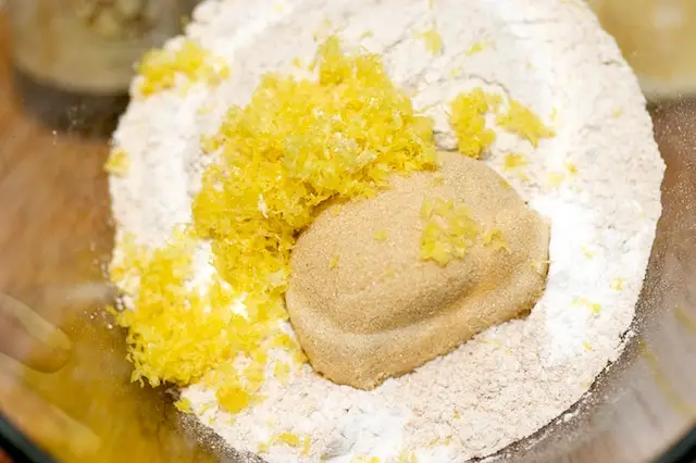 In anther bowl, add the flour, sugar, baking powder, baking soda, salt, and lemon zest,