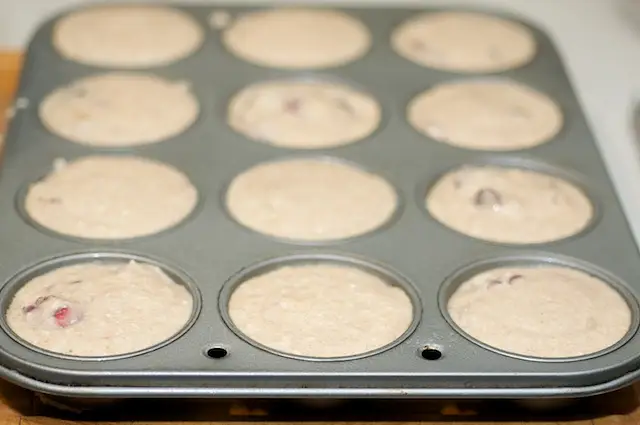 Divide the batter evenly among the 12 muffin cups.