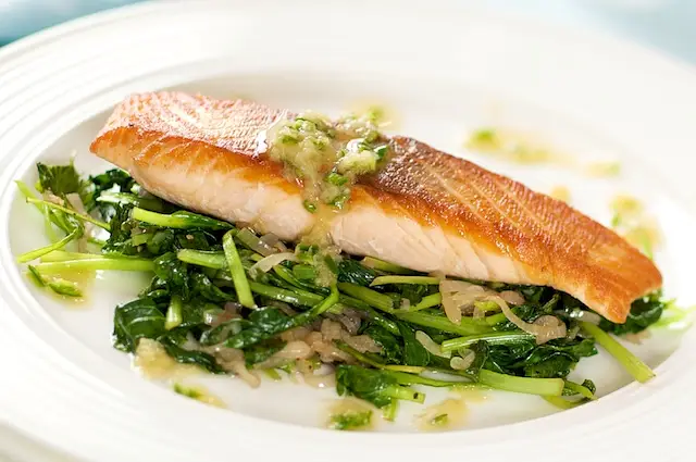 Spoon the sauce over the fish and vegetables.