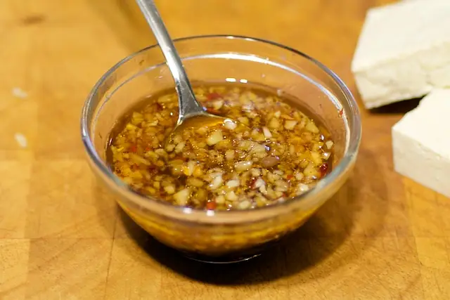 Add the soy sauce, rice vinegar, honey, lime juice, ginger, garlic, scallions if using, red pepper flakes to taste and sesame into a small bowl, and whisk until well combined. 