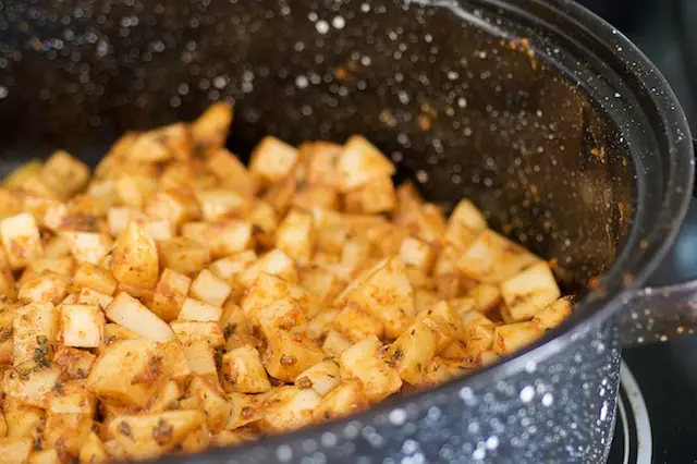 Spread the potato cubes evenly into a baking pan.