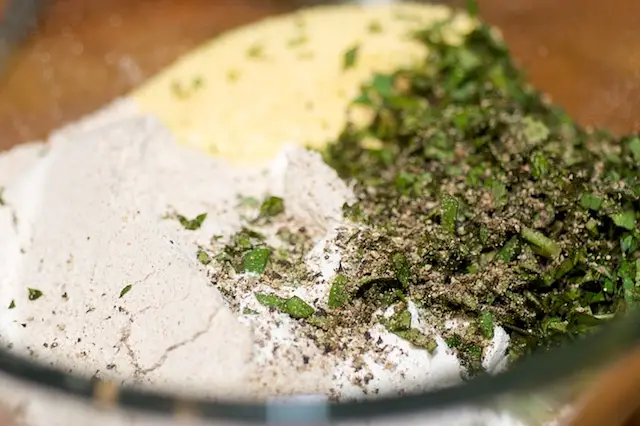 Add all the dry ingredients including herbs into a large bowl.