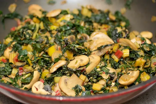 Add the chard leaves, stems and kale leaves, stirring,