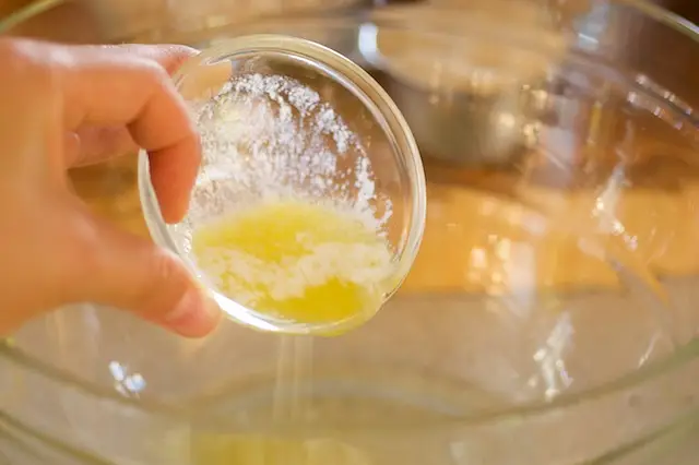 Add the melted butter and applesauce.