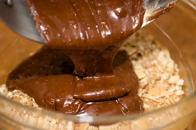 Pour the mixture over the oats, 