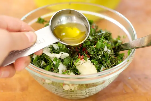 Remove the stems, finely chop all the fresh herbs, red chili peppers, and mince the garlic.