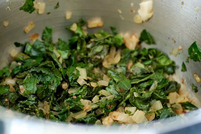 Add the kale into the cooked onions and saute, stirring, cook until wilted about 2 minutes. 