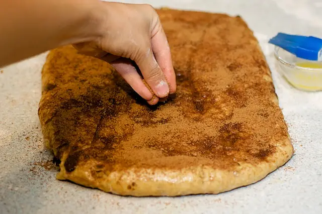 Sprinkle the cinnamon sugar evenly over the dough.