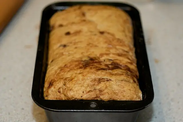Place the seam side down in 9 by 5-inch loaf pan greased with butter. 