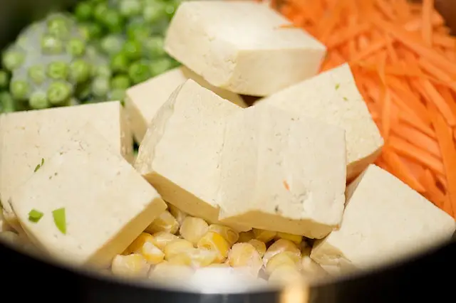 Add the carrots, peas, corn and tofu.