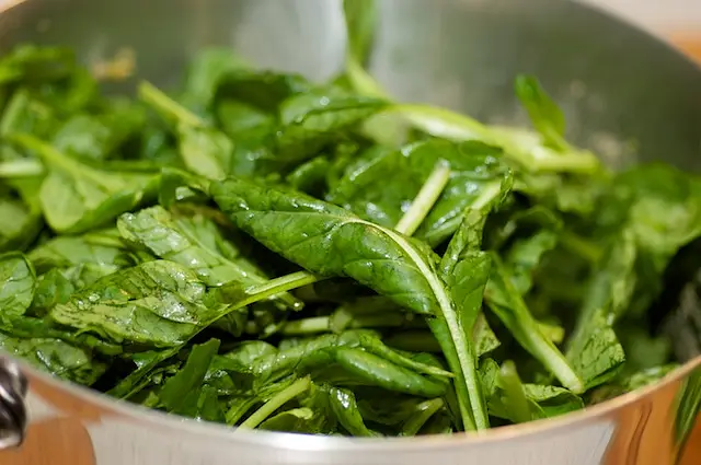 Remove the pot from the heat, and stir in the tatsoi until the leaves are witled.