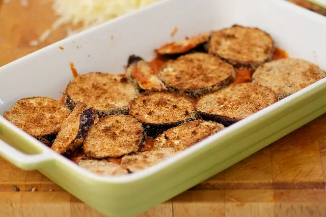 Arrange eggplant slices on tomato mixture.