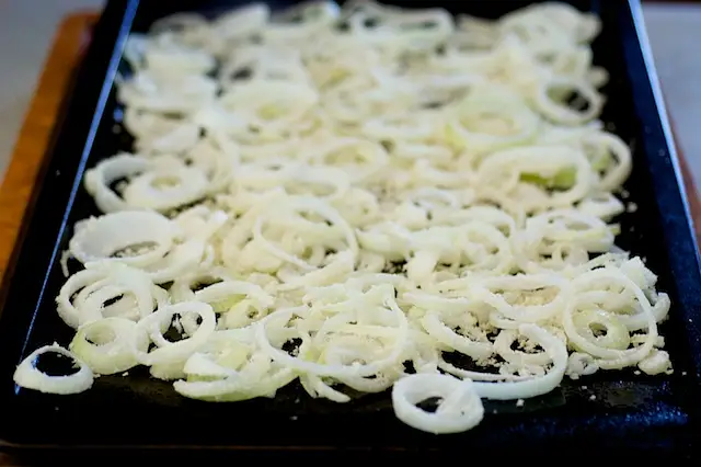 Arrange onion slices on a baking pan