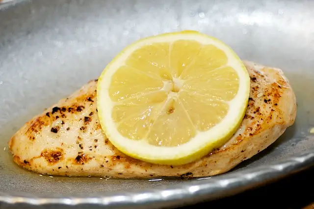 Slice the rest of the lemon and place a lemon slice on top of each chicken piece. 