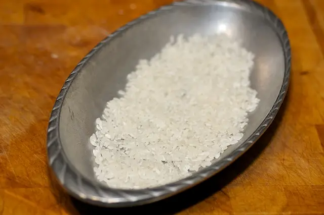 Add the rice into a <a href="/how-to/baking-pan-and-dish-volume-guide" title="Baking Pan and Dish Volume Guide">baking dish</a>  