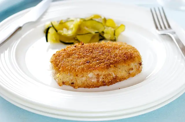 Put the pork chops in the hot skillet and cook until golden brown and crispy, about 4 minutes.