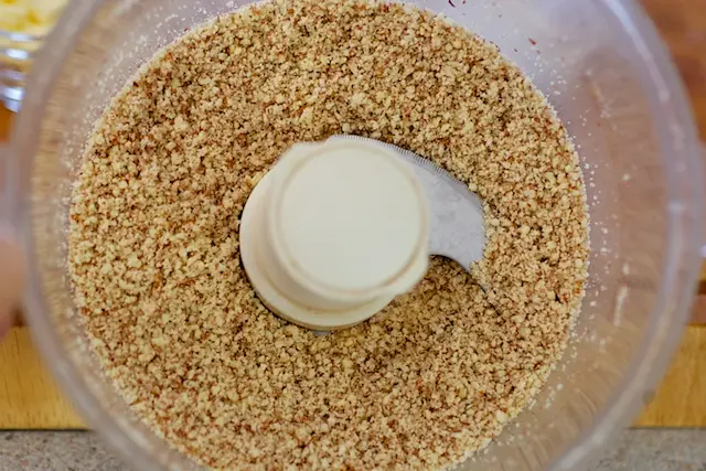 Grind the almonds in a food processor until finely ground.